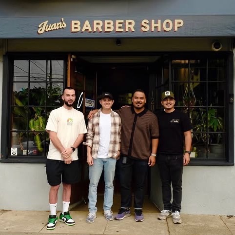 Four of the barbers standing together outside Juan’s Barbershop